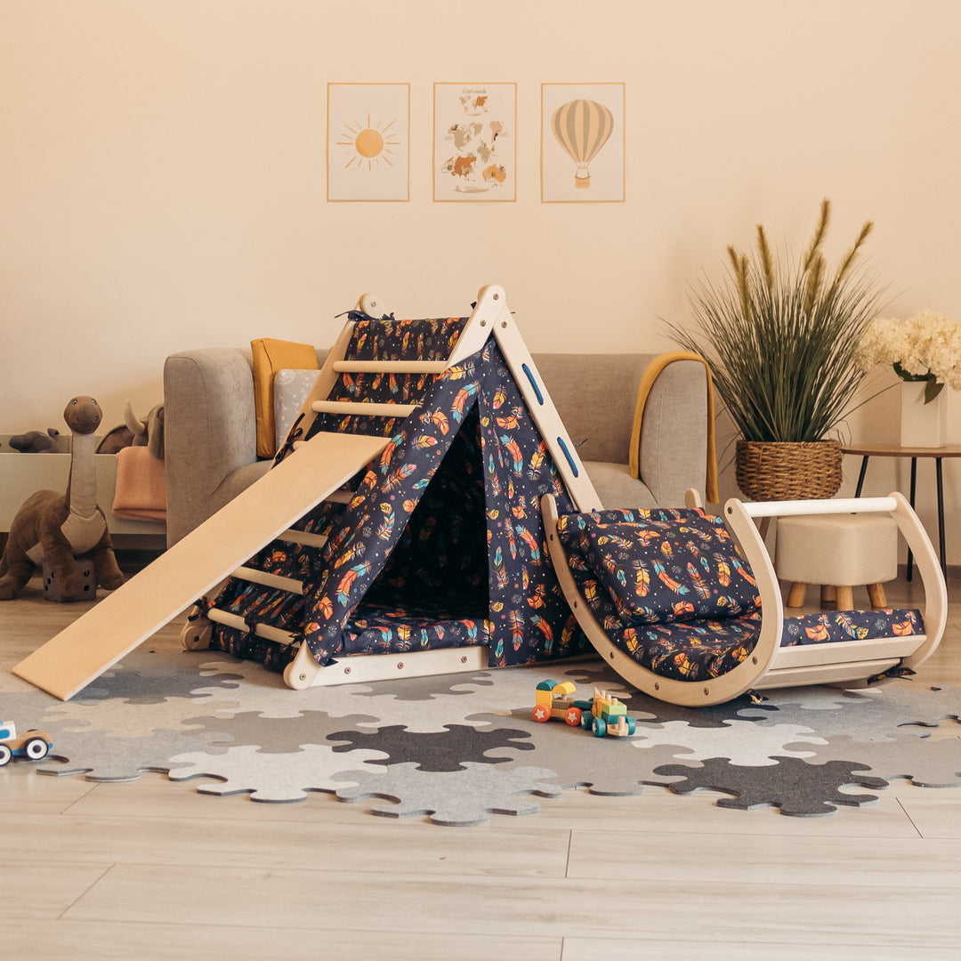 Climbing set for children with climb up triangle, mattresses, tent, sliding board and rocking toy.
