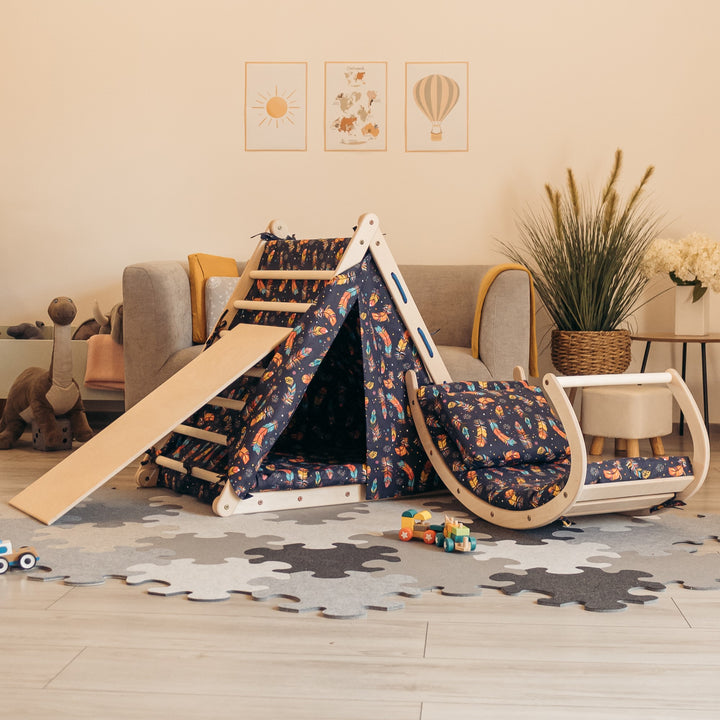 Climbing set for children with climb up triangle, mattresses, tent, sliding board and rocking toy.